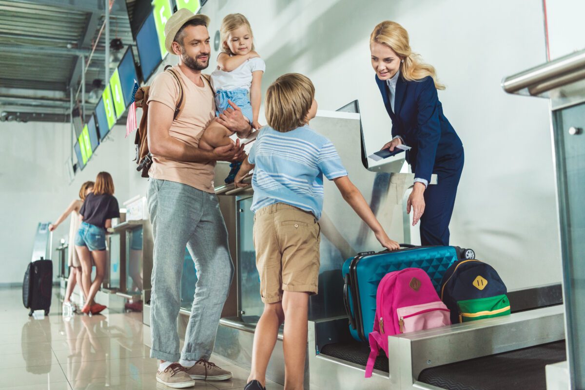 A man and two children are at the airport.