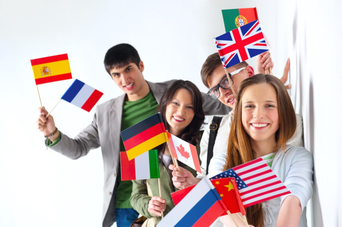 A group of people holding flags and smiling.