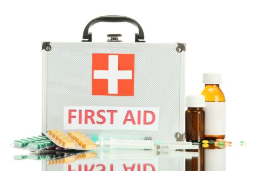 A first aid kit with medical supplies on it.